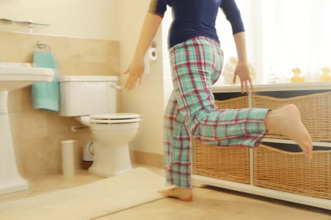 Woman experiencing signs of an overactive bladder