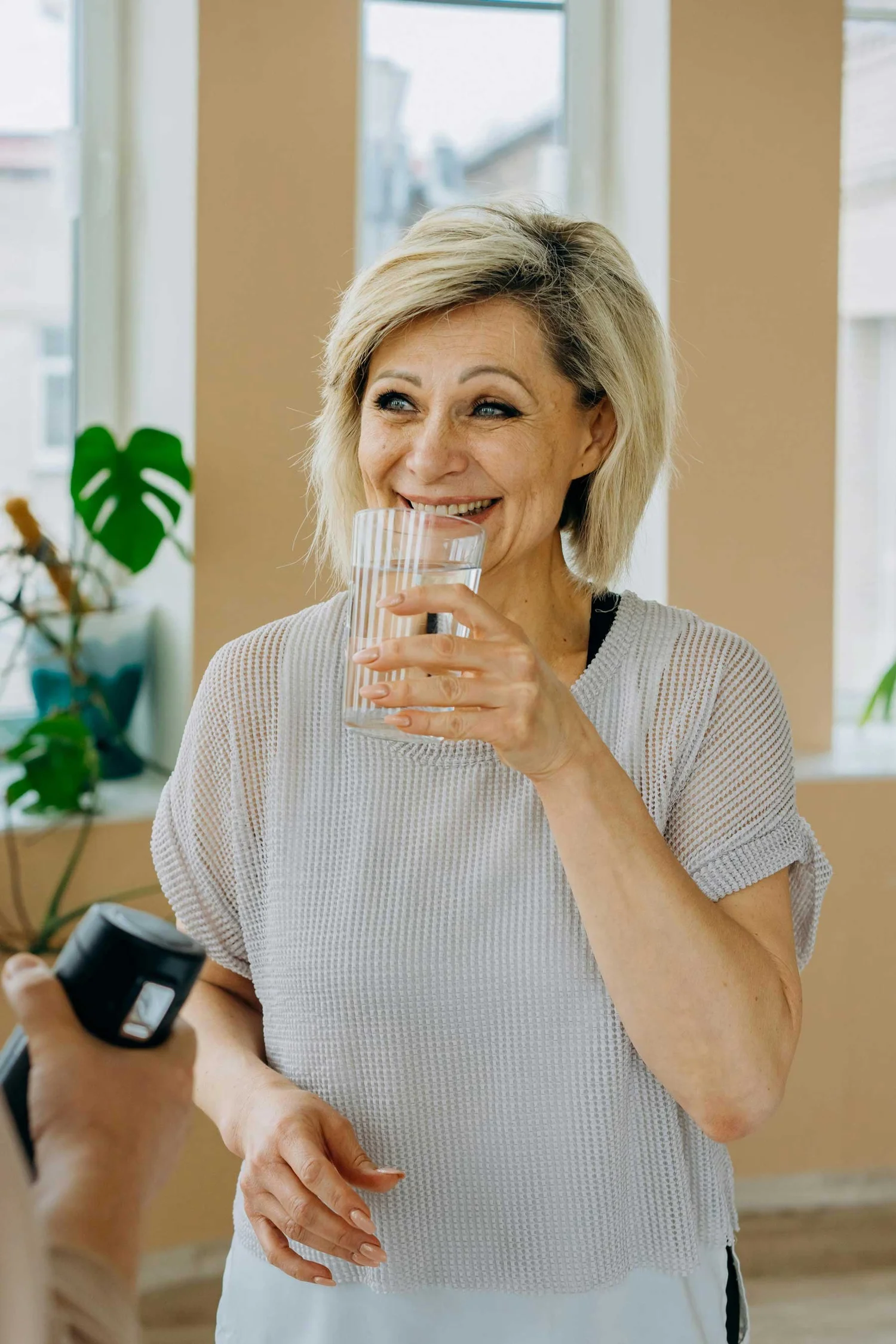 Woman drinking water while learning about bladder control and pelvic floor health